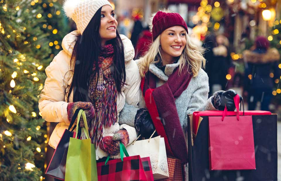 promo image for young women doing winter birthday christmas shopping using holiday savings account